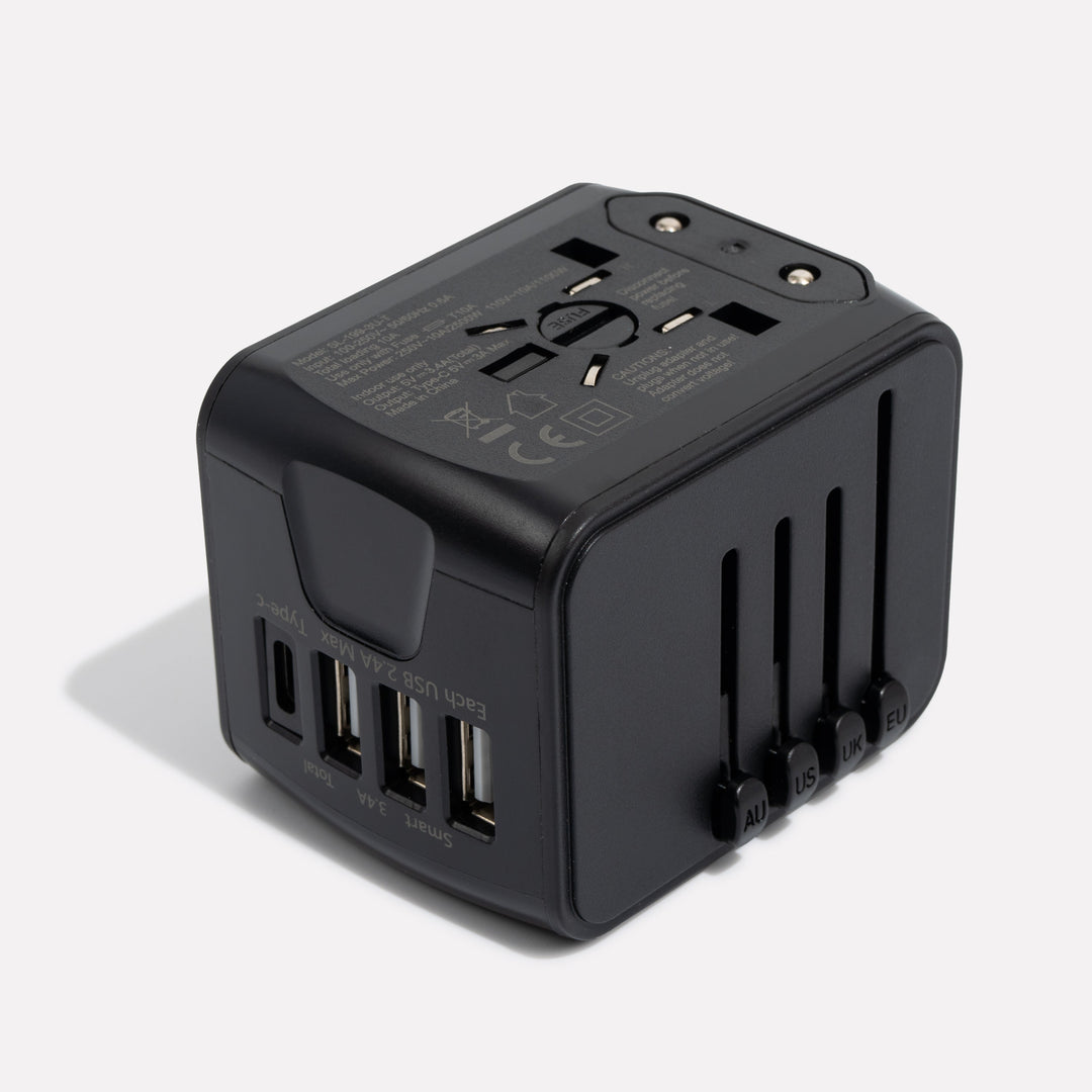 Black adapter at an angle, showing three USB-A ports, one USB-C port and the four plug sliders 4