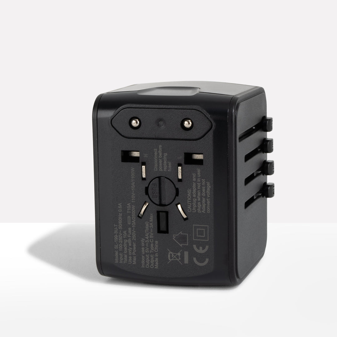 Black travel adapter seen from the back, showing the fixed two-pin plug and fuse cover 1