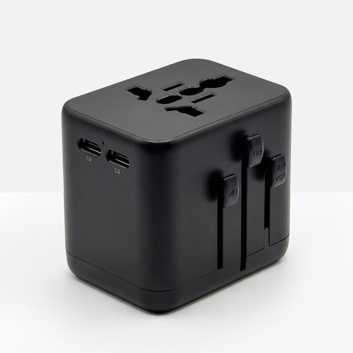 All-black adapter with two USB-C ports, the universal socket on top and three plug sliders 11
