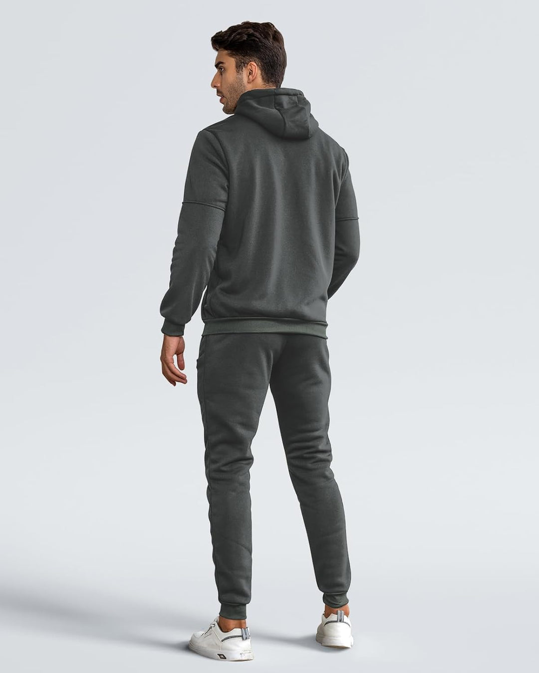 Back view of a model wearing the gray hoodie and joggers with white sneakers 10
