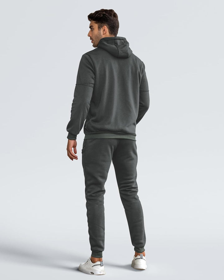 Back view of a model wearing the gray hoodie and joggers with white sneakers 10