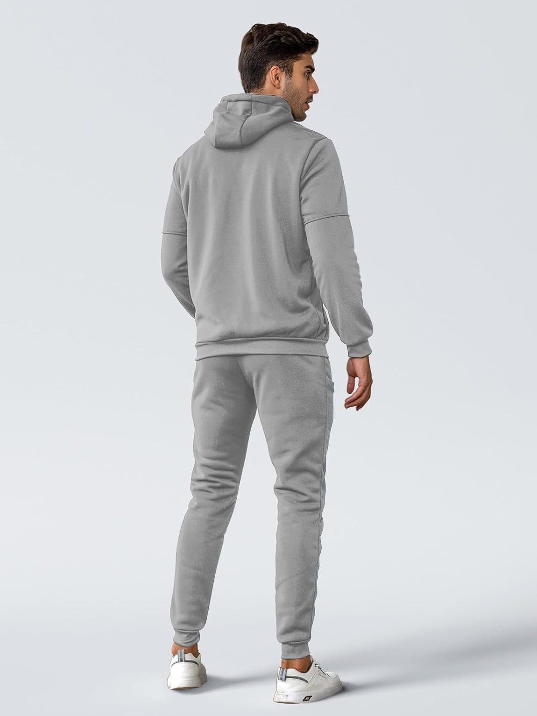 Back view of a man in a light gray hoodie and matching jogger pants 15