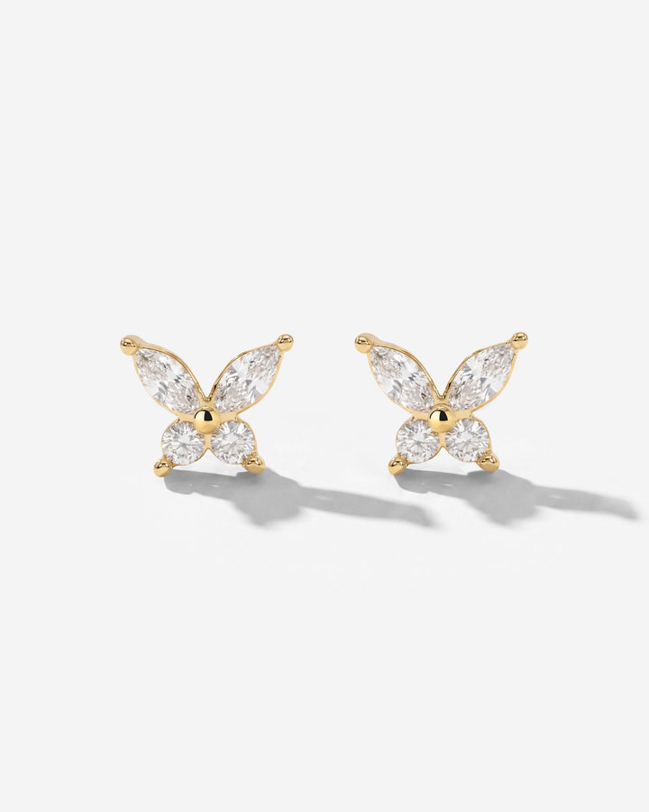 Pair of gold-tone butterfly studs with clear stones, seen from the front on a white surface 2
