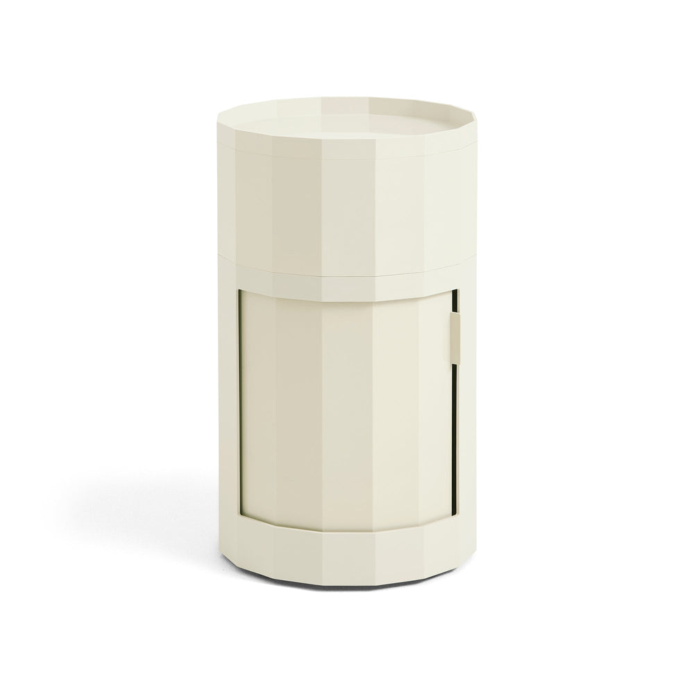 Cream-colored tall round cabinet with twelve-sided body, tray top and closed door, shown on white 2