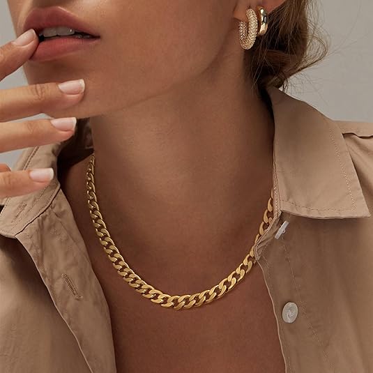 Gold chain necklace on a model in a beige button-up shirt, with chunky gold earrings 2
