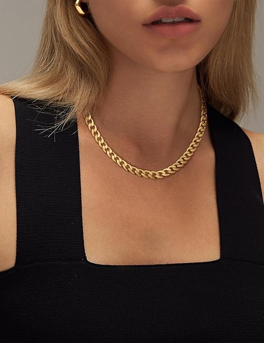 Model in a black square-neck top wearing the gold chain, framed from lips to chest 5