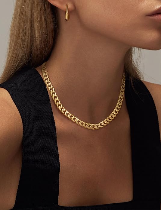 Side-angle view of the gold chain on a model with long hair and a gold drop earring 6