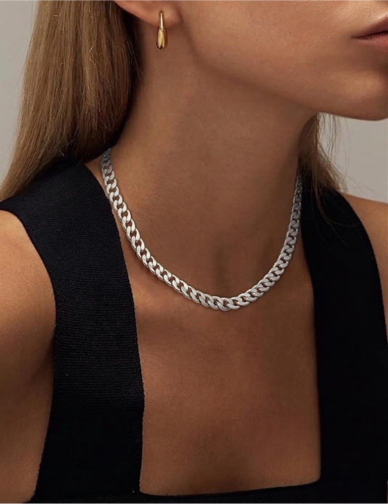 Side view of the silver-tone chain on a model with long straight hair and a small gold earring 10