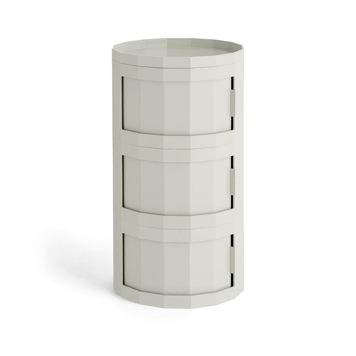 Front view of a light gray three-tier cylindrical cabinet with three swivel doors and a rimmed top 41