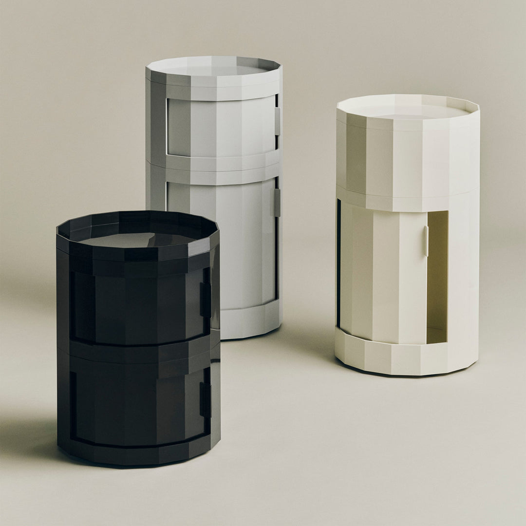 Black, light gray and cream cabinets in different heights, the cream one with its door open 53