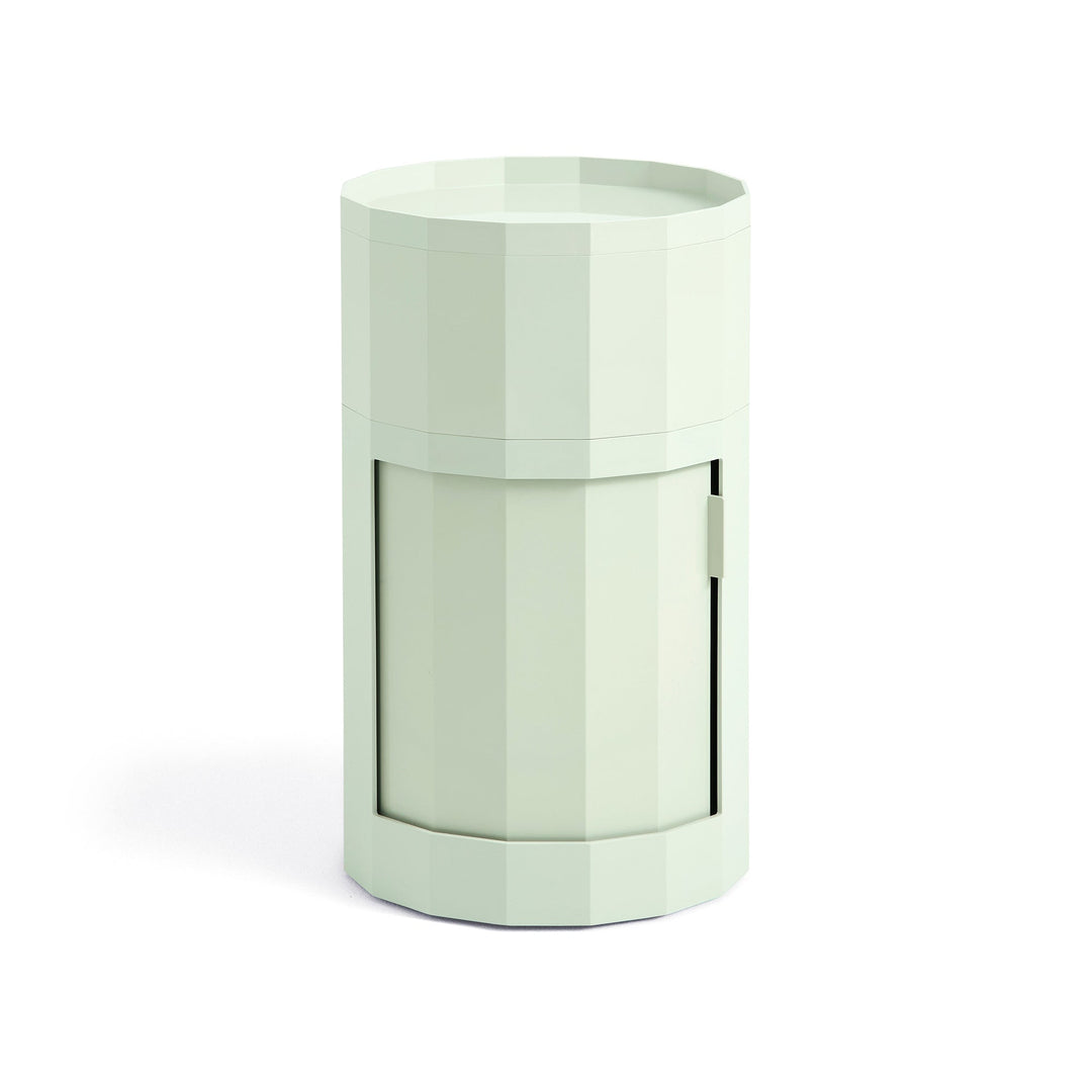 Tall round cabinet in pale mint green with faceted sides, tray top and closed door 17