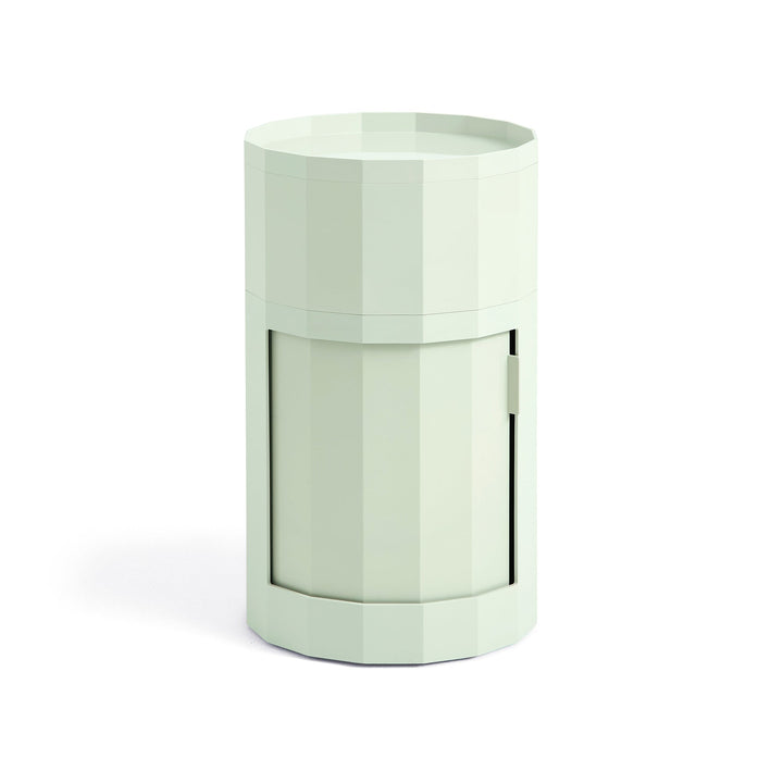 Tall round cabinet in pale mint green with faceted sides, tray top and closed door 17