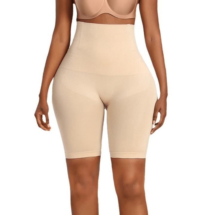 Close-up front view of beige high-waisted shaping shorts worn by a model from bra line to knees 13