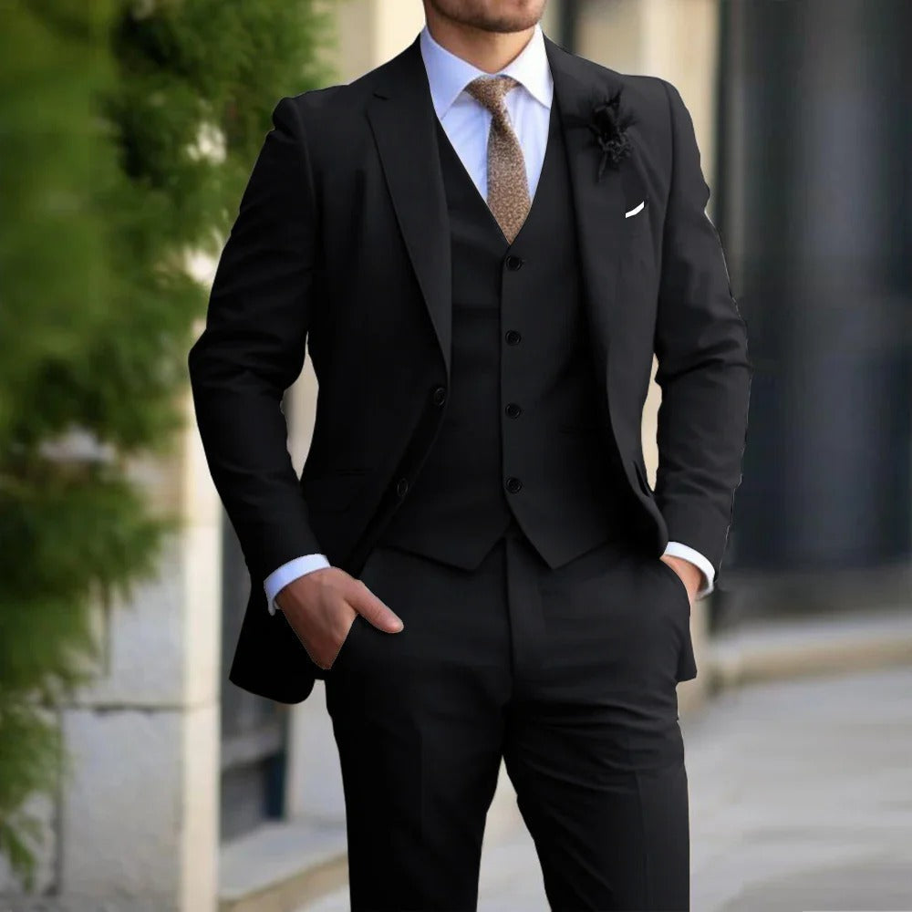 Same three-piece suit in black, worn with a white shirt and brown tie outdoors 4
