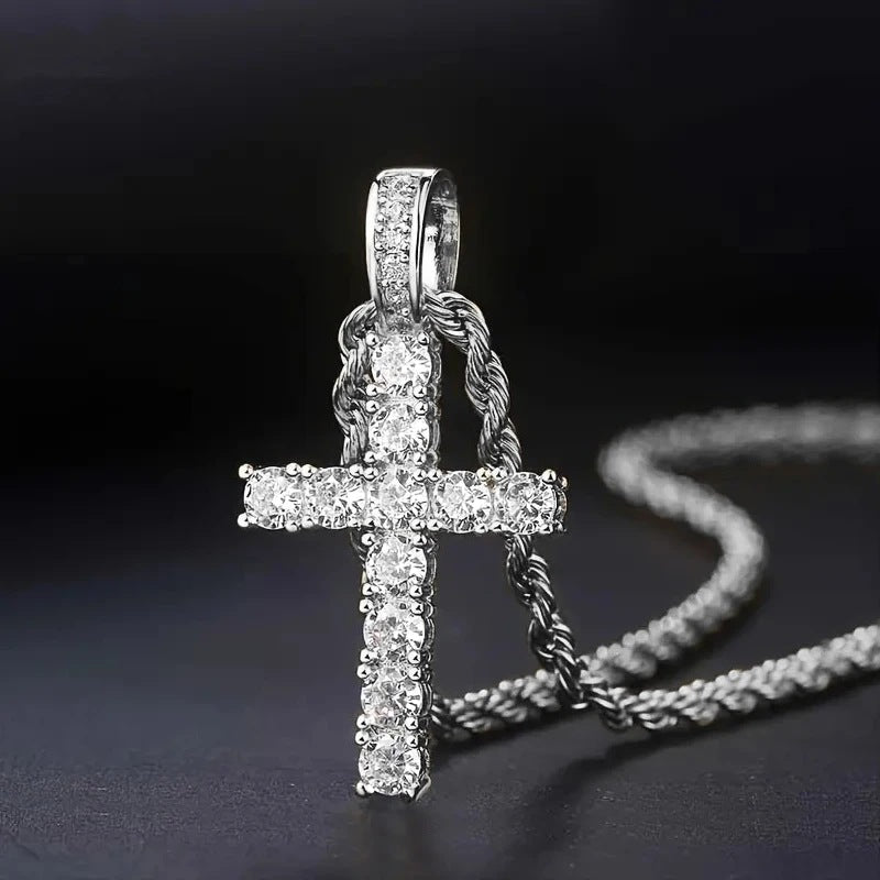 Silver-tone version of the stone-set cross pendant on a twisted rope chain against a dark background 2