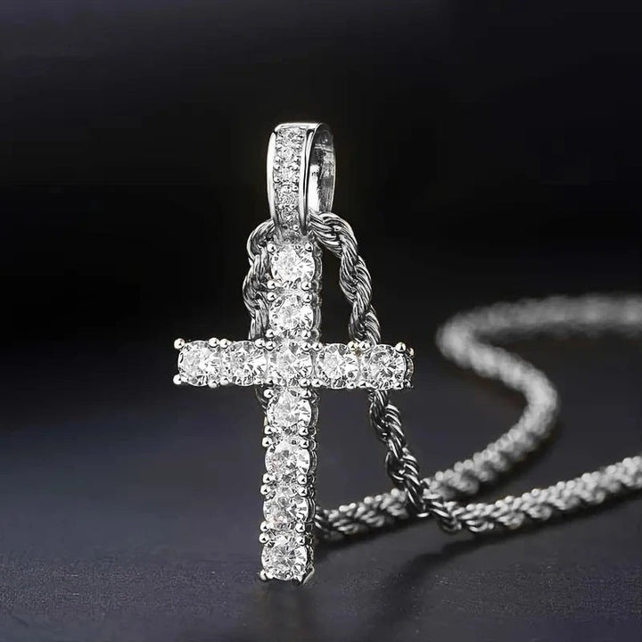 Silver-tone version of the stone-set cross pendant on a twisted rope chain against a dark background 2