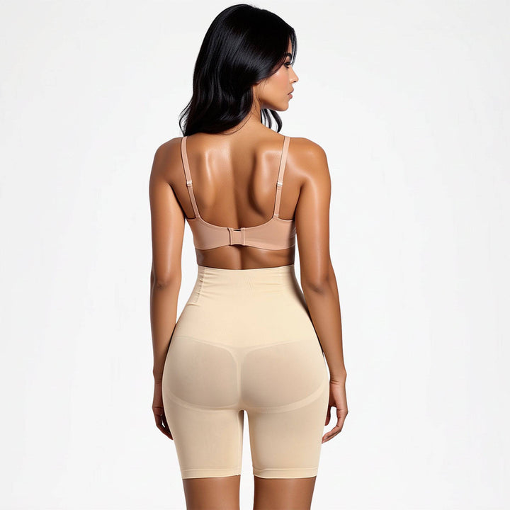 Back view of a model in beige high-waisted shaping shorts and a nude bra 11
