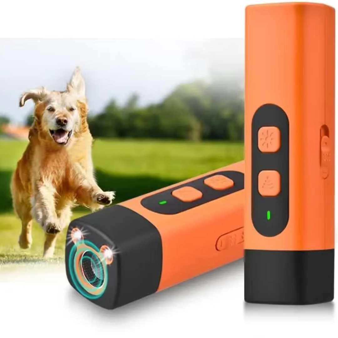 Two orange and black handheld devices in front of a golden retriever running across a green field 1