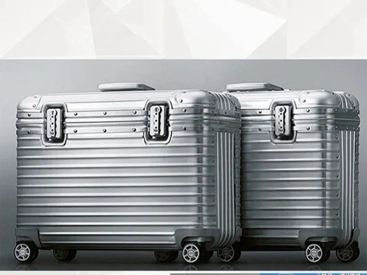 Two silver ribbed cases side by side against a gray backdrop, showing locks and spinner wheels 5