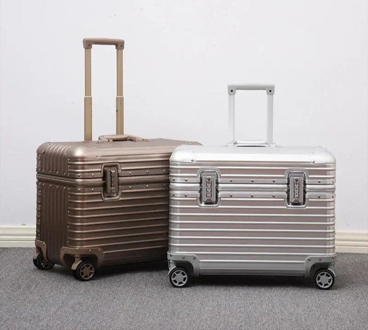 Bronze and silver grooved suitcases stand side by side with telescoping handles extended 7