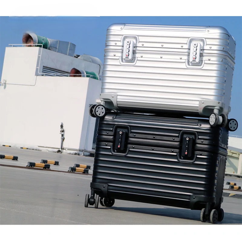 Silver case stacked on a black one outdoors, both showing front combination locks and spinner wheels 2