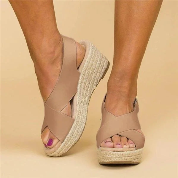 Front and side view of tan crisscross wedge sandals with open toes and braided jute soles 3
