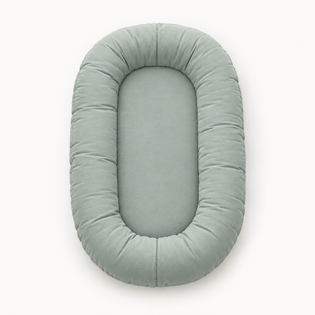 Empty sage-green oval lounger with a raised padded rim, seen from above on white 8