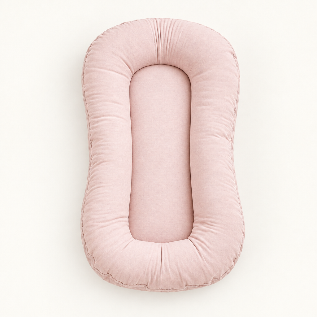 Empty blush-pink lounger with a padded rim and oval center, seen from above 10
