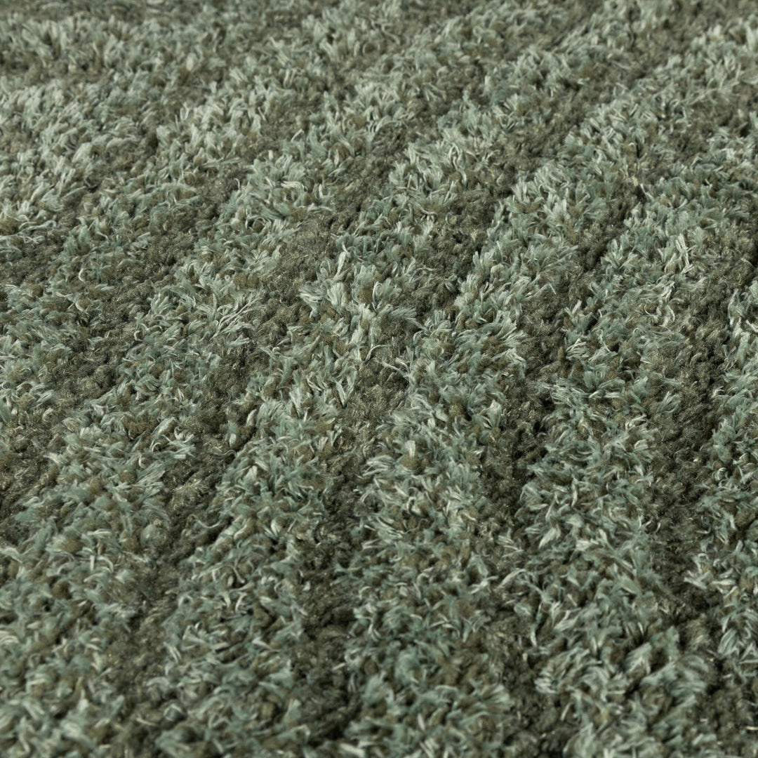 Close-up of the soft green shaggy pile with its two-tone fibers filling the frame 4