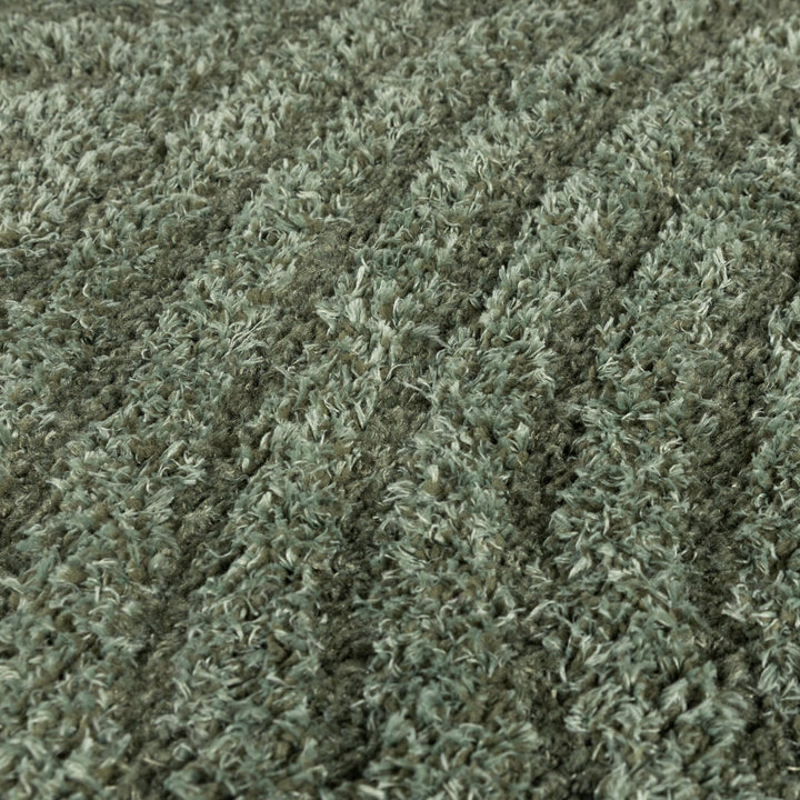 Close-up of the soft green shaggy pile with its two-tone fibers filling the frame 4