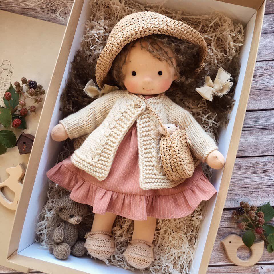 Doll in a crocheted straw hat, cream cardigan and rose ruffled dress in a box with a small knitted bear 8