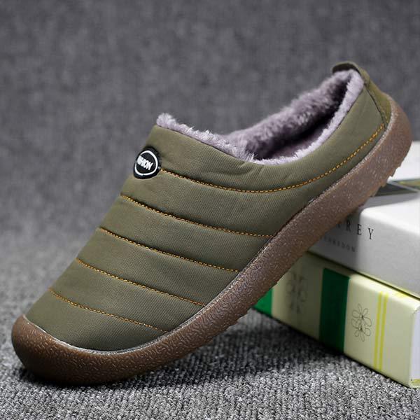 Single olive green quilted slipper tilted on a stack of books, showing the side profile and fleece lining 4