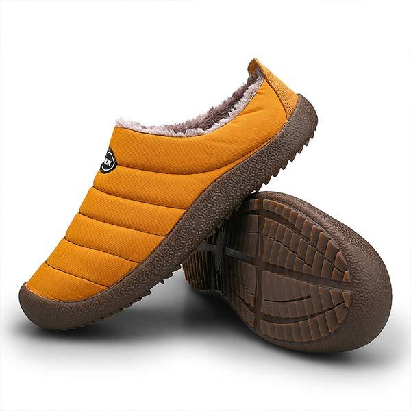 Mustard quilted slipper beside a second one stood on its side, revealing the treaded brown outsole 12
