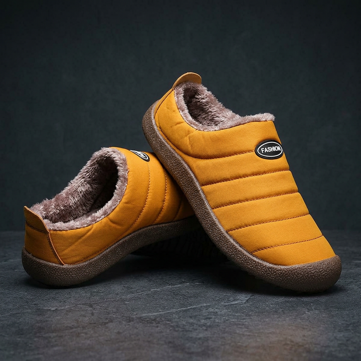 Pair of mustard yellow quilted slippers with plush lining, one leaning on the other on a dark surface 20