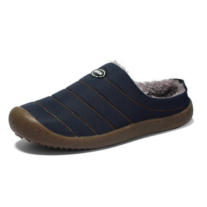 Single navy blue quilted slipper with fleece lining, angled view on a white background 15