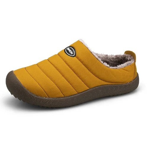 Single mustard yellow quilted slipper with fleece lining, angled view on a white background 13