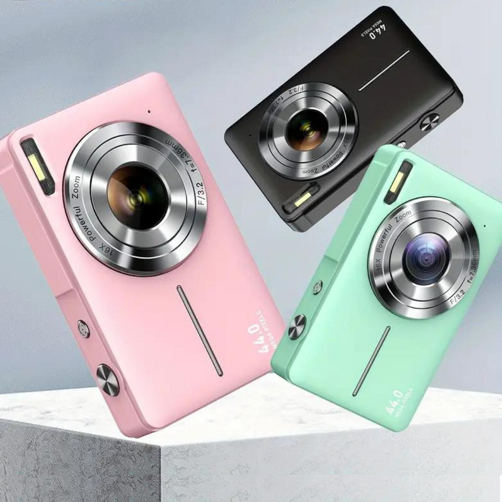 Pink, black and mint green cameras tilted at angles above a gray concrete block 2