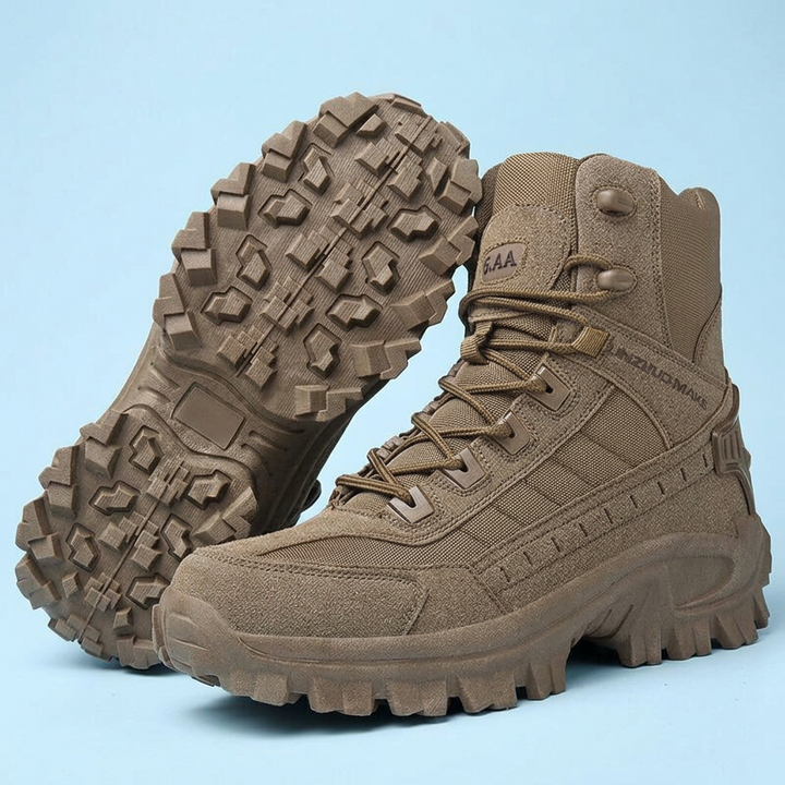 Brown high-top boots on a pale blue background, one upright and one propped up to show the lugged outsole 26