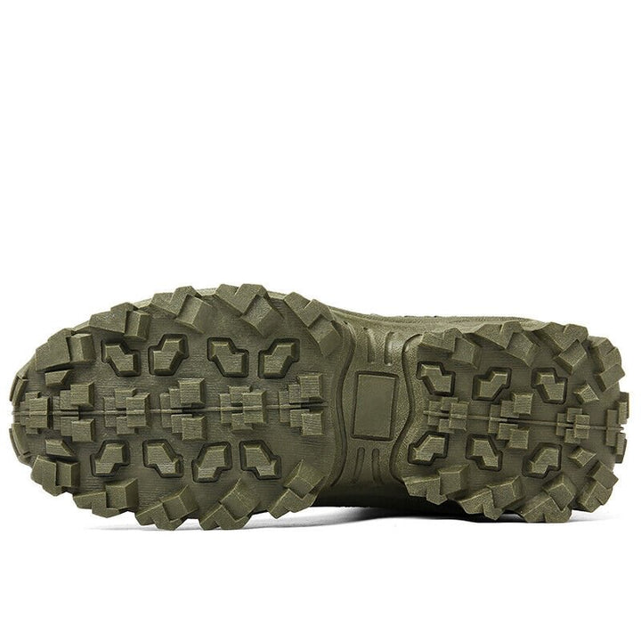 Close view of the olive green boot's outsole, showing deep blocky lugs and a flat center panel 22