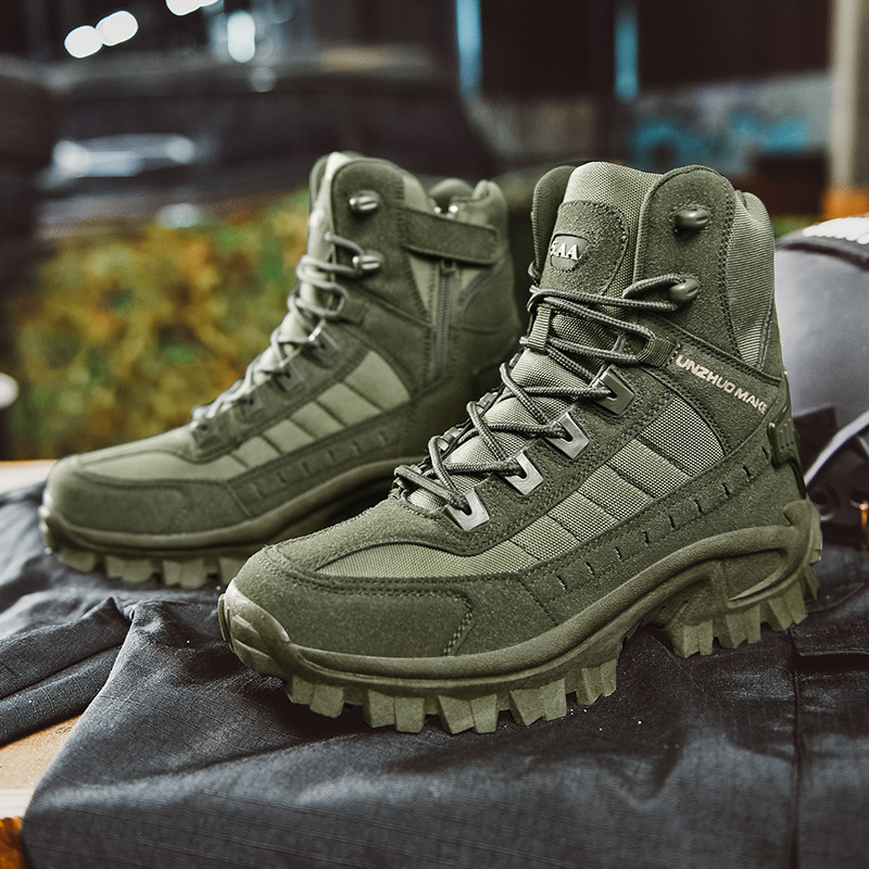 Pair of olive green boots on dark fabric, with one angled to show its zipper and strap 6