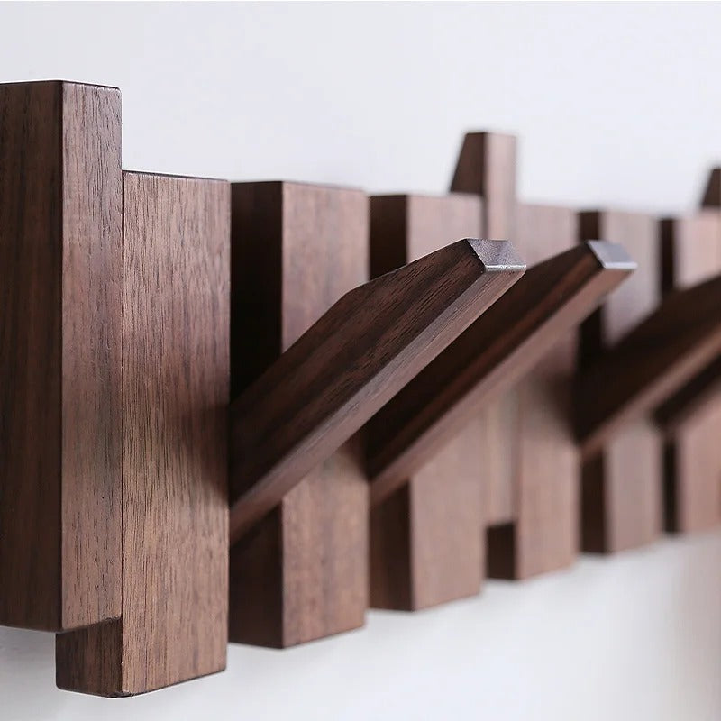 Close-up of dark wood grain on the rack, with several hooks angled outward from the slats 7